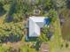 Aerial view of a single story home with a large backyard and surrounding trees at 1035 S State Road 415, New Smyrna Beach, FL 32168