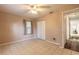 Bedroom with tile floor, ceiling fan, and access to another room at 1035 S State Road 415, New Smyrna Beach, FL 32168