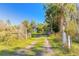 Long driveway leading to house with gate at 1035 S State Road 415, New Smyrna Beach, FL 32168