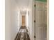 Clean hallway with light walls and a floral rug at 1035 S State Road 415, New Smyrna Beach, FL 32168