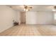 Bright living room featuring tile floors and ceiling fan at 1035 S State Road 415, New Smyrna Beach, FL 32168