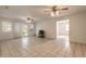 Spacious living area with tile floors and two ceiling fans at 1035 S State Road 415, New Smyrna Beach, FL 32168