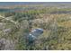 Aerial view showing a house with a pool, surrounded by lush greenery at 1371 Melonie Trl, New Smyrna Beach, FL 32168