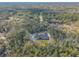 Aerial view showcasing a single-story home with a pool, surrounded by trees at 1371 Melonie Trl, New Smyrna Beach, FL 32168