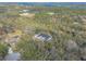 Aerial view of a house nestled in a lush, wooded area with a pool and spacious lot at 1371 Melonie Trl, New Smyrna Beach, FL 32168