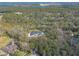 An aerial shot of a house with a pool, situated amongst the trees and greenery at 1371 Melonie Trl, New Smyrna Beach, FL 32168