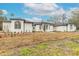 White two-story house with a gray roof, arched windows, and walkway at 1371 Melonie Trl, New Smyrna Beach, FL 32168