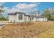 House exterior with landscaping and driveway at 1371 Melonie Trl, New Smyrna Beach, FL 32168