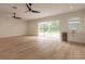 Bright living room featuring hardwood floors and sliding glass doors at 1371 Melonie Trl, New Smyrna Beach, FL 32168