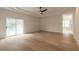 Main bedroom with hardwood floors and sliding glass doors to the pool at 1371 Melonie Trl, New Smyrna Beach, FL 32168