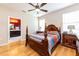 Main bedroom with hardwood floors, en-suite bathroom access, and wooden furniture at 3447 Poneta Ave, New Smyrna Beach, FL 32168