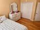 Bedroom with wood floors, white dresser, and double door closet at 3447 Poneta Ave, New Smyrna Beach, FL 32168