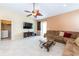 Bright living room with tile floors, comfy sectional sofa, and large TV at 3447 Poneta Ave, New Smyrna Beach, FL 32168