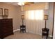 Bedroom with dresser, two bedside tables with lamps, carpet flooring, and decorative wall art above the window at 400 Oakridge Blvd # 6, Daytona Beach, FL 32118