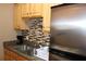 Eat-in kitchen featuring stainless steel appliances and tile backsplash at 400 Oakridge Blvd # 6, Daytona Beach, FL 32118
