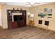 Open living room featuring wood-look floors, a ceiling fan, and a media center for cozy living at 400 Oakridge Blvd # 6, Daytona Beach, FL 32118