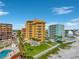 Aerial view showcasing the condo, pool, well-manicured lawn, and beachfront location at 701 N Atlantic Ave # 202, New Smyrna Beach, FL 32169