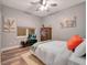 Cozy bedroom with a neutral color scheme, wood floors, a ceiling fan, and soft lighting at 701 N Atlantic Ave # 202, New Smyrna Beach, FL 32169