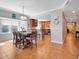 Open-concept dining area with a modern chandelier and seamless flow into the kitchen space at 701 N Atlantic Ave # 202, New Smyrna Beach, FL 32169