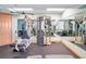 Home gym with exercise equipment, mirrors, and light blue walls for a calming workout space at 701 N Atlantic Ave # 202, New Smyrna Beach, FL 32169