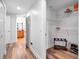 Hallway view of a walk-in closet with shelving and a glimpse into the main bathroom with granite countertops at 701 N Atlantic Ave # 202, New Smyrna Beach, FL 32169