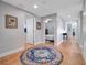 Inviting hallway with neutral walls and a decorative rug leading to various rooms within the home at 701 N Atlantic Ave # 202, New Smyrna Beach, FL 32169