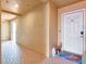 Hallway leading to condo front door, featuring tiled floors and beach-themed decor at 701 N Atlantic Ave # 202, New Smyrna Beach, FL 32169