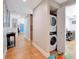 Hallway featuring tile flooring, a washing machine, and access to the laundry room at 701 N Atlantic Ave # 202, New Smyrna Beach, FL 32169