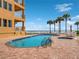 Beachside pool with a jacuzzi, lounge chairs, and palm trees at 701 N Atlantic Ave # 202, New Smyrna Beach, FL 32169