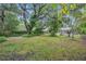 Lush backyard with mature trees and a brick pathway at 798 E 11Th Ave, New Smyrna Beach, FL 32169