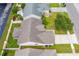An aerial view of the home with lush lawn, modern roof, and surrounding neighborhood at 1277 Harms Way, Port Orange, FL 32129