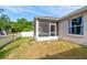 Home's backyard with a screened-in lanai and a well-kept lawn surrounded by a block fence at 1277 Harms Way, Port Orange, FL 32129