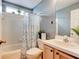Bathroom featuring a shower-tub combo, toilet, vanity, and decor at 1277 Harms Way, Port Orange, FL 32129