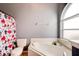 This bathroom features a tub, toilet, and a window providing natural light at 1277 Harms Way, Port Orange, FL 32129