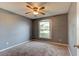Bedroom with neutral carpet, a ceiling fan, and a window allowing natural light at 1277 Harms Way, Port Orange, FL 32129