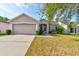Charming single-story home with a well-maintained lawn and attached two-car garage at 1277 Harms Way, Port Orange, FL 32129