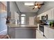 Well-lit kitchen with stainless steel appliances, granite counters, and white cabinetry at 1277 Harms Way, Port Orange, FL 32129