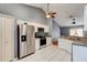 Functional kitchen with white cabinets, stainless steel appliances, tile flooring, and granite countertops at 1277 Harms Way, Port Orange, FL 32129