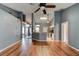 Open-concept living room featuring hardwood flooring, gray walls, and high ceilings at 1277 Harms Way, Port Orange, FL 32129