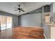 Spacious living room with sliding glass doors, hardwood floors, and neutral gray walls at 1277 Harms Way, Port Orange, FL 32129