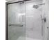 Modern shower with marble walls and a rain shower head at 2616 Belmont Ave, New Smyrna Beach, FL 32168