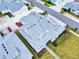 An aerial view of a single Gathering home with a light gray roof, green lawn, and walkway in a residential neighborhood at 452 Lime Ave, Daytona Beach, FL 32124