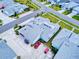 Aerial view showcases ample parking with a garage, golf cart, and two cars on the property at 452 Lime Ave, Daytona Beach, FL 32124