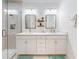 Bright bathroom featuring double vanity, shower, framed mirrors, and modern fixtures at 452 Lime Ave, Daytona Beach, FL 32124