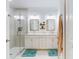 Bright bathroom featuring double vanity, shower, framed mirrors, and modern fixtures at 452 Lime Ave, Daytona Beach, FL 32124