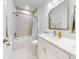 Bright bathroom with a white vanity, marble countertop, and a shower-tub combo, offering a clean and modern look at 452 Lime Ave, Daytona Beach, FL 32124