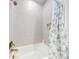 Close-up of a bathtub with tiled walls and shower curtain, showcasing a clean and functional bathroom space at 452 Lime Ave, Daytona Beach, FL 32124