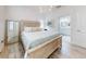Primary bedroom with hardwood floors, decorated headboard, a mirror, and en-suite bathroom at 452 Lime Ave, Daytona Beach, FL 32124