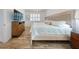 Light and airy bedroom with bright hardwood floors and a decorative headboard with white shutters at 452 Lime Ave, Daytona Beach, FL 32124