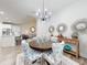 Light and airy dining area featuring modern chandelier, wood table, and decor in a neutral color palette at 452 Lime Ave, Daytona Beach, FL 32124